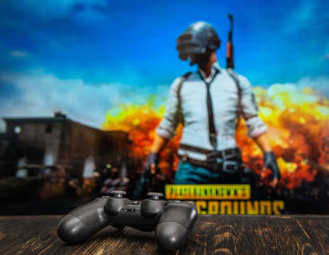 Odessa, Ukraine - May 12, 2019. Black playstation 4 gamepad on the background of the game PUBG.  PLAYERUNKNOWN'S BATTLEGROUNDS  Battle Royale shooting game.