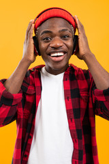 attractive black american guy listening to music on headphones