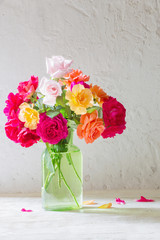 roses in vase on background white wall