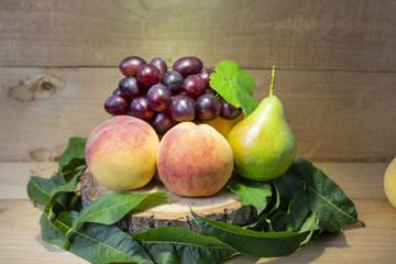 Fresh fruits. Healthy food. Mixed fruit, peaches, grapes, pears. Studio photography of various fruits on an old wooden table. Organic healthy assorted fruits. Assortment of fresh fruit. Fruit food bac