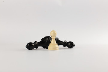 Black bishop and white pawn isolated on white background