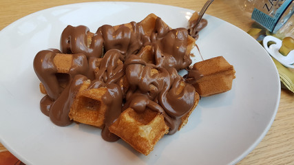 waffle chocolated hot  liquid on the plate