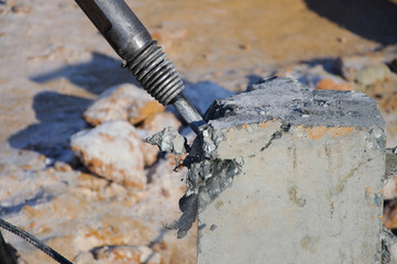 A large jackhammer during work. Demolition with a jackhammer.