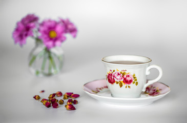 Fototapeta na wymiar A cup of tea with dried roses