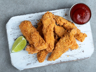 crispy fried breaded chicken breast strips and sauce