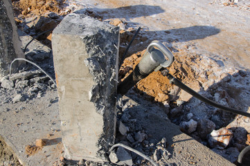The working part of the jackhammer is a close-up. Demolition with a jackhammer