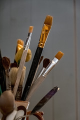 Art brushes are placed in a pot