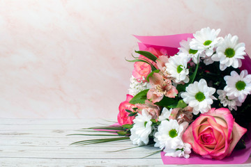 A bouquet of blooming delicate flowers, a festive pink background, a delicate pastel bouquet, a floral card, for March 8.