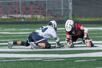 Young athletes making amazing plays while playing in a Lacrosse game