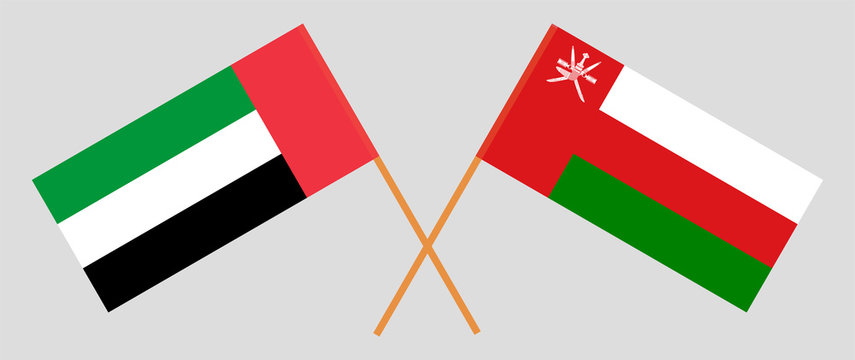 Crossed flags of Oman and the United Arab Emirates
