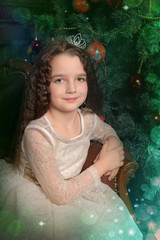 girl in ivory festive dress in christmas with a crown