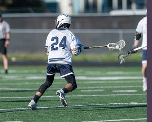 Young athletes making amazing plays while playing in a Lacrosse game