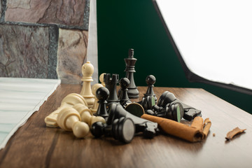 Obraz na płótnie Canvas Chess figures mix on a wooden desk