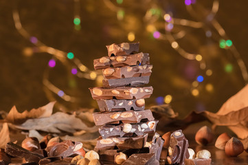 Tower of chocolate chunks with hazelnuts and leaves