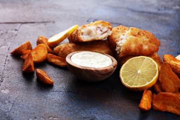 traditional British fish and chips consisting of fried fish, potato chips and mayonnaise