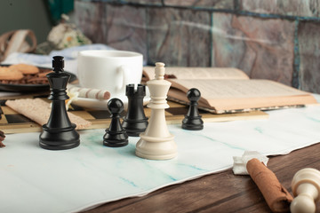 Chess figures and a book on the table