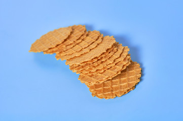 Scattered many thin round waffles on purple background. Losing weight concept