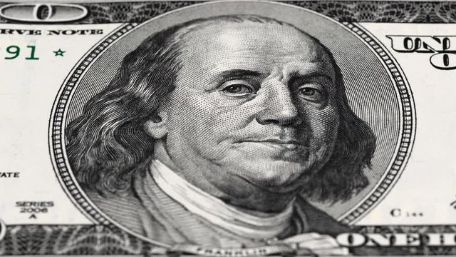 Benjamin Franklin portrait on US 100 dollar bill tracking. 100 USD. Low angle, macro. 4K