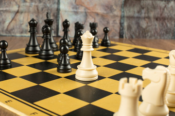 Black figures against white league on the chessboard