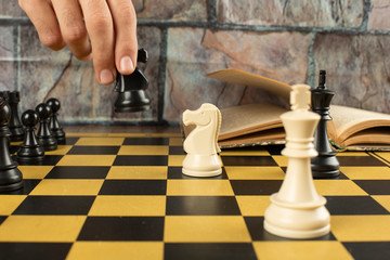 Chess figures position and a player playing chess