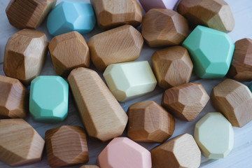 Educational games for children. Wooden figures of different sizes, shapes and colors.