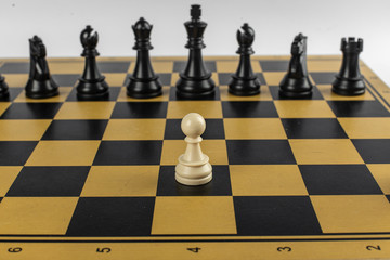 A pawn against black team on chessboard