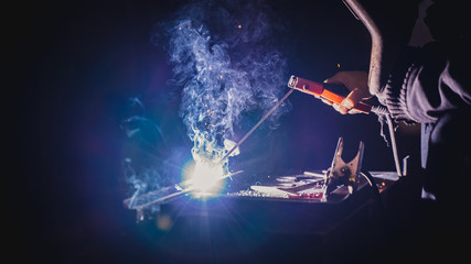 arc welding worker at action close up sparks