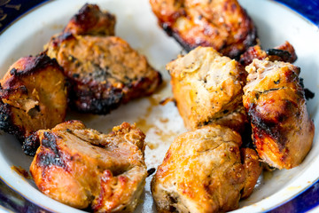 Pieces of kebab removed from skewers and put on a plate.