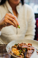 Squeezing Lime Wedge on Food