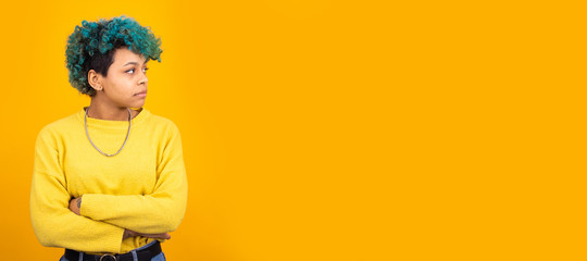 young brunette woman with trendy blue hair isolated on color background