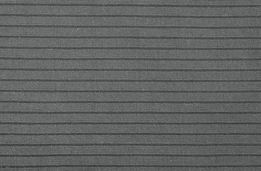 Texture of black plastic striped relief fabric. Overhead shot. Closeup shot. Macro photography....