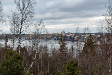 View from the shore of the bay to the ancient city of Vyborg and the port on a cloudy spring day