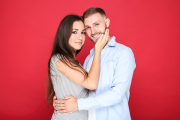Happy young couple on red background