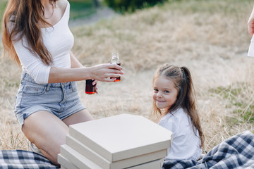 little girl having fun at picnic, pizza, drinks, summer and lawn