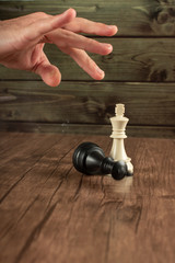 A hand, checkmate, king and queen
