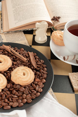 Cookies and a tea cup on a chessboard