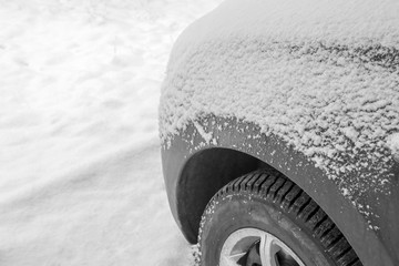 snow-covered car on the background of snow