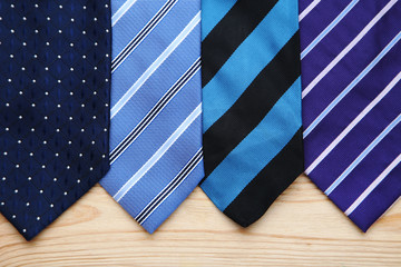 Colorful neckties on brown wooden table