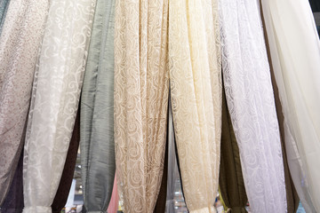 Display stand with the sale of different curtains in the store. Close-up