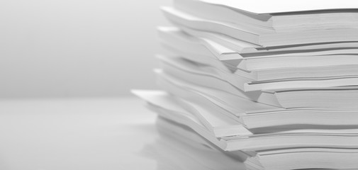 Several stacks of white paper on a white background