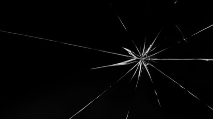 Obraz premium Round white cracks in glass on black background.