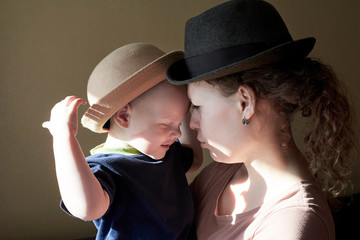 Portrait of mom and son in retro hats.