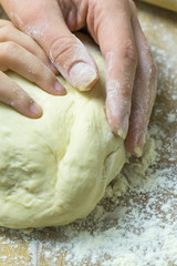 Manual kneading of dough for cooking homemade food.