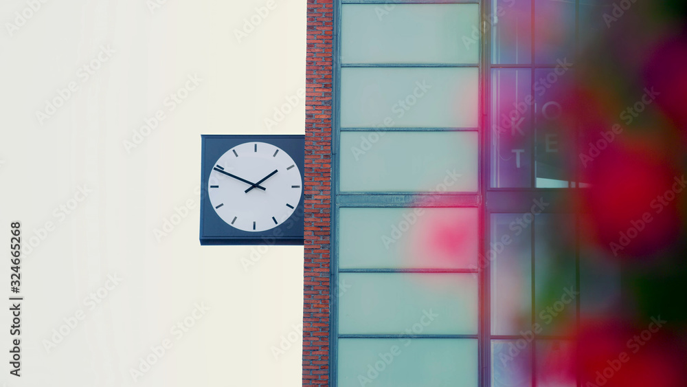 Poster close-up large dial clock attached to the side of a brick building in helsinki