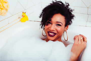 young pretty african american girl taking bath with foam, lifestyle people concept
