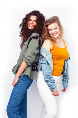 Fototapeta na wymiar young pretty teenage girls friends with blond and brunette curly hairs posing cheerful isolated on white background, lifestyle people concept