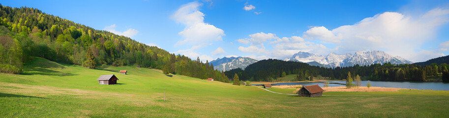 Fototapeta na wymiar wide landscape panorama lake gerold and pasture with huts, view to karwendel mountains