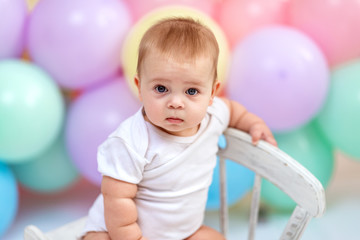 Fototapeta na wymiar Сute baby boy on the background of balloons
