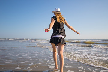 happy woman are playing on the seashore