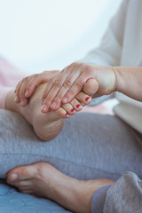 Obraz na płótnie Canvas Hand making thai feet massage. Alternative medicine and thai massage concept 